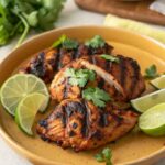 Grilled copycat chipotle chicken garnished with lime