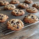 Freshly baked banana bread cookies with chocolate chips cooling on a wire rack – perfect for a banana bread cookies recipe.