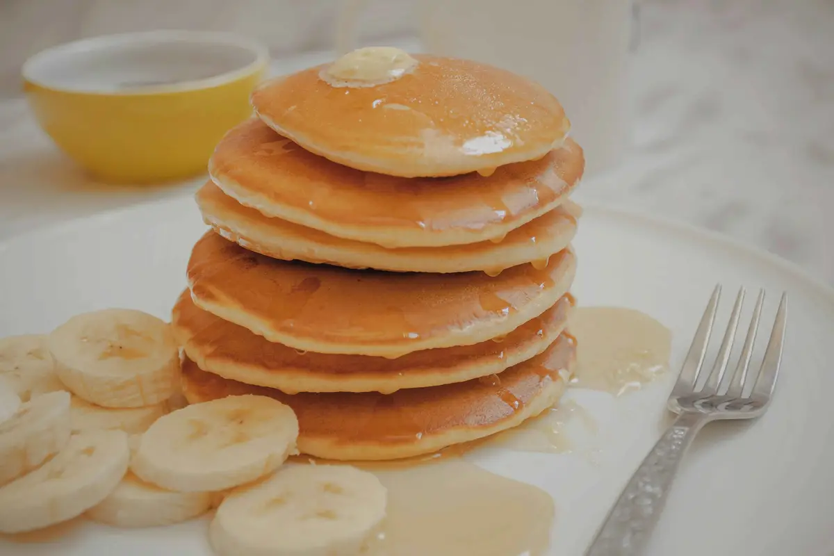 Stack of gluten free vegan pancakes with banana slices
