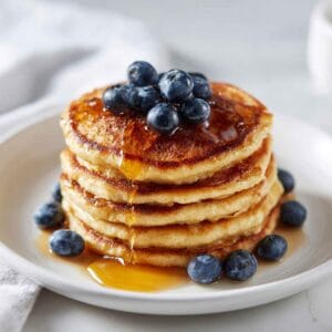 Golden fluffy gluten free pancakes with syrup