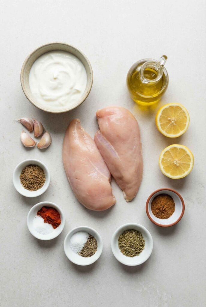 Ingredients for yogurt marinated chicken breast including yogurt and chicken