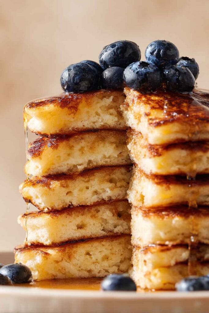 Close-up of high protein cottage cheese pancakes showing airy interior structure and evenly browned exterior.