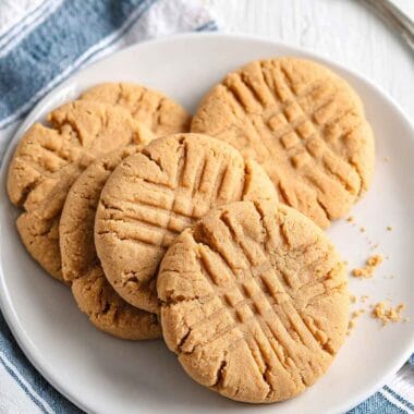 Easy peanut butter protein cookies served on a white plate with classic fork marks