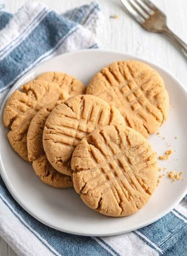 Easy peanut butter protein cookies served on a white plate with classic fork marks