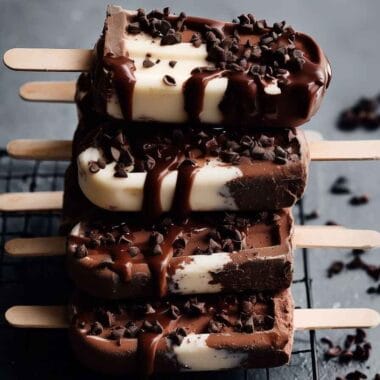 Greek yogurt ice cream bars with chocolate drizzle and chocolate chips on cooling rack