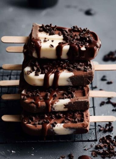 Greek yogurt ice cream bars with chocolate drizzle and chocolate chips on cooling rack