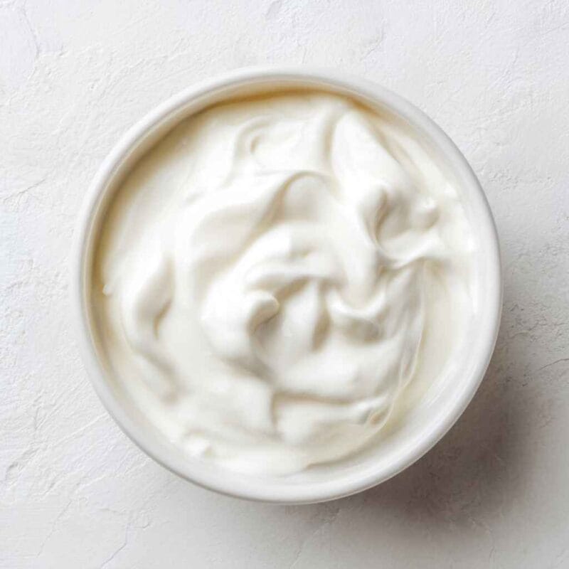 thick greek yogurt in a mixing bowl before adding chia seeds and milk