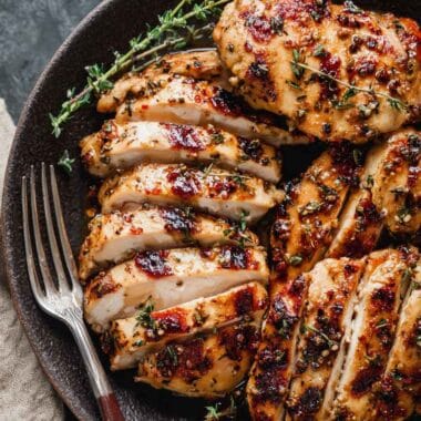 high protein chicken thighs sliced and seasoned with spices served on a plate