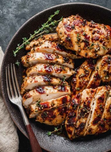 high protein chicken thighs sliced and seasoned with spices served on a plate