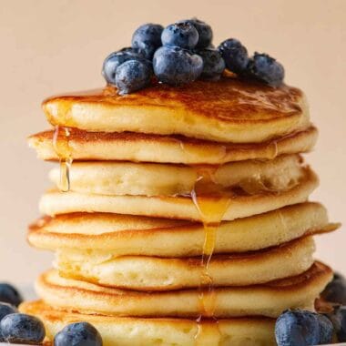 High protein cottage cheese pancakes with 22g protein, topped with blueberries and maple syrup