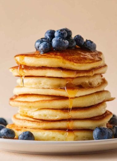 High protein cottage cheese pancakes with 22g protein, topped with blueberries and maple syrup
