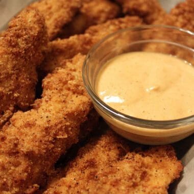Low calorie chicken strips served crispy with dipping sauce