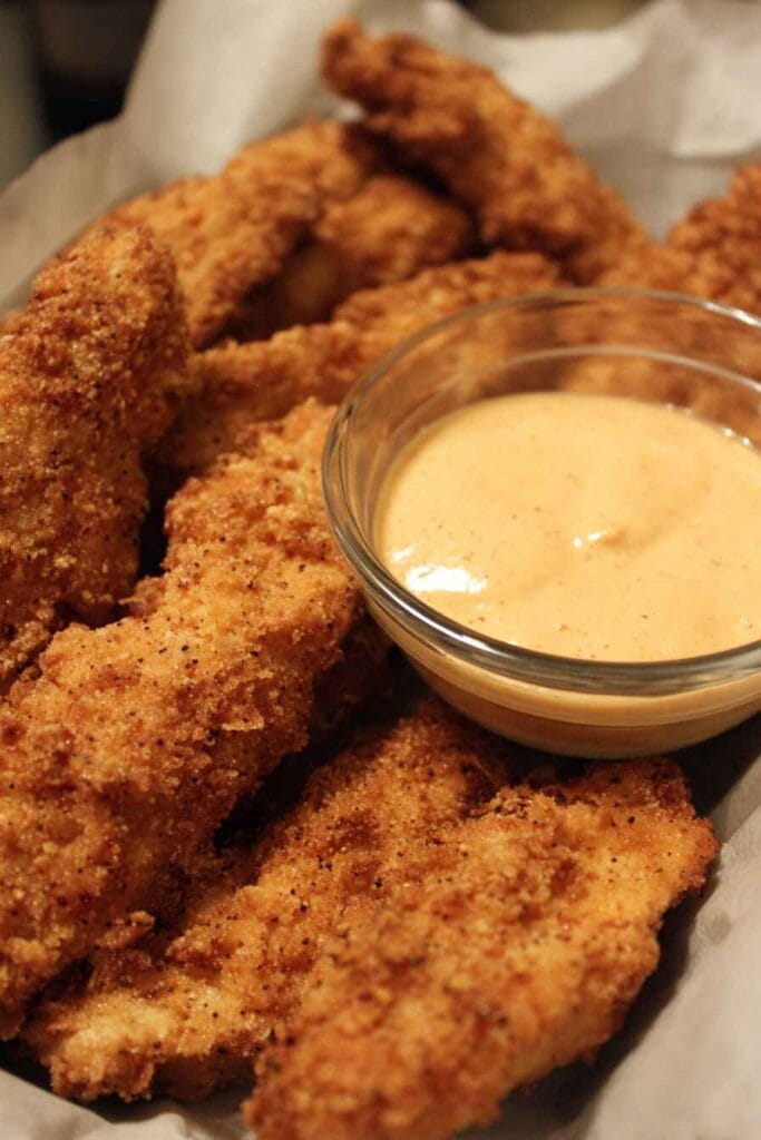 Low calorie chicken strips served crispy with dipping sauce