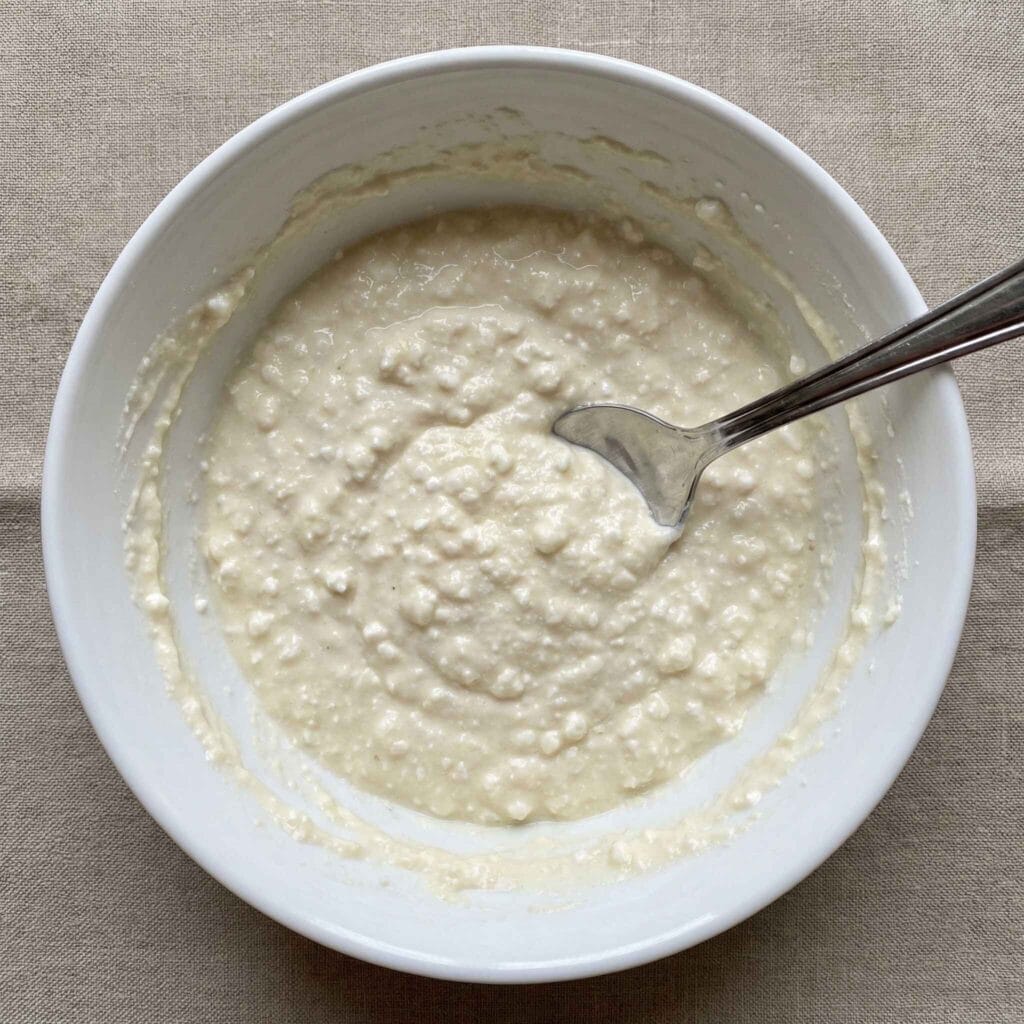 thick cottage cheese pancake batter in a white bowl.