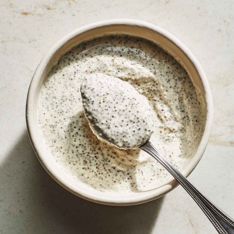 mixed greek yogurt chia pudding with spoon showing creamy texture