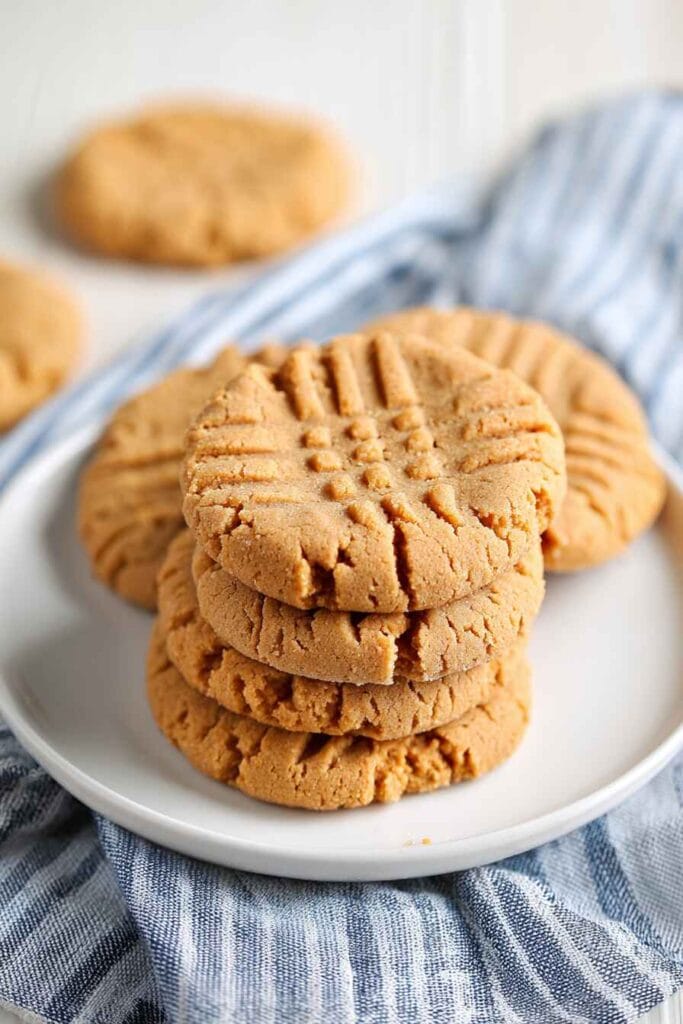 Peanut butter protein cookies stacked on a plate showing soft thick texture