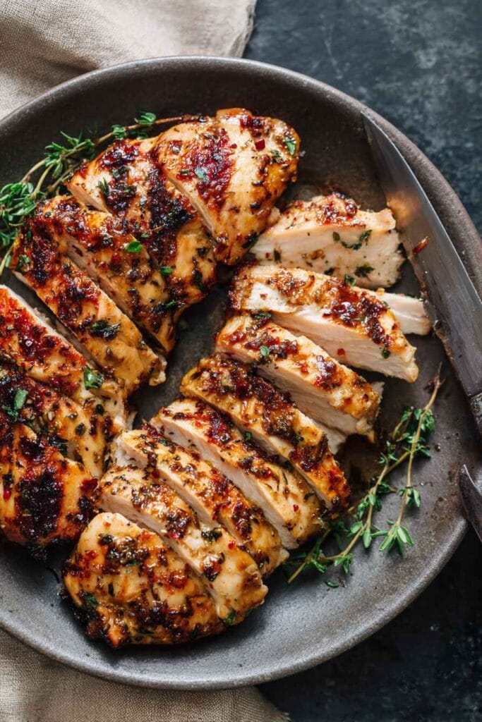 sliced high protein chicken thighs coated with garlic, paprika, and herbs