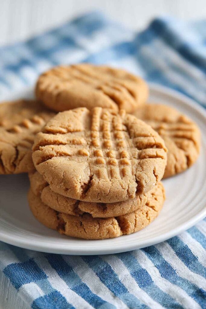 Peanut butter protein cookies stacked on a plate showing thick soft texture