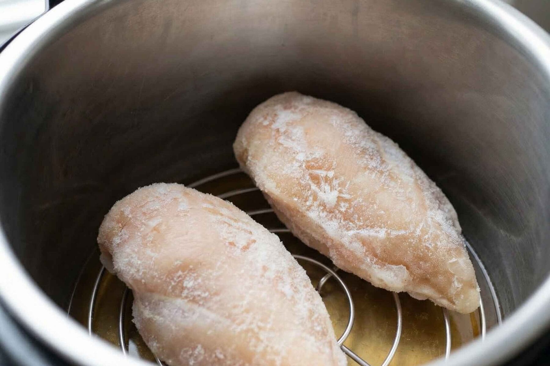 Place chicken in Instant Pot frozen chicken breast in instant pot on trivet