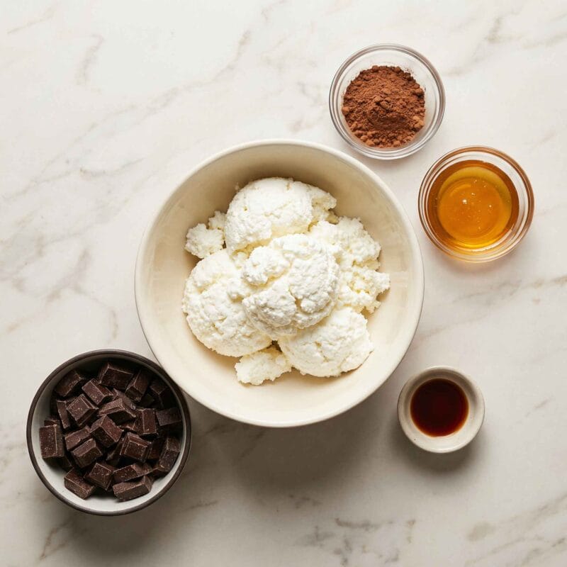 ingredients for cottage cheese chocolate bites healthy in small bowls top view