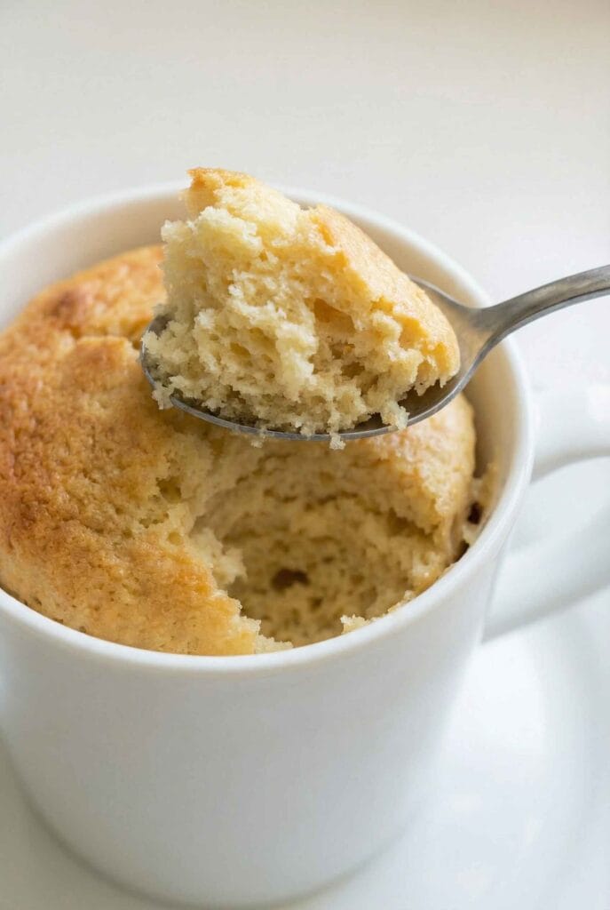 Fluffy high protein mug cake texture on a spoon showing soft and airy inside