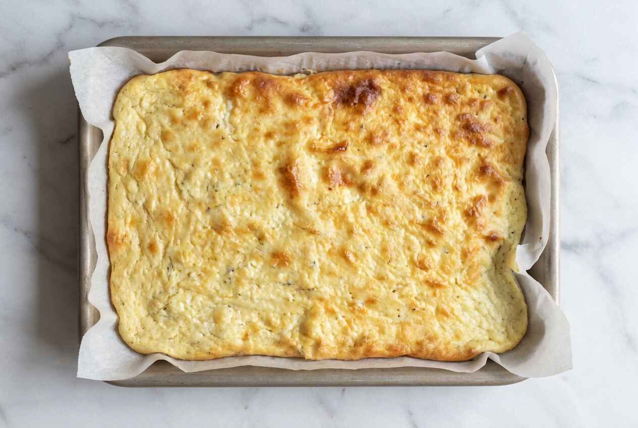 high protein cottage cheese flatbread fresh out of oven in baking pan